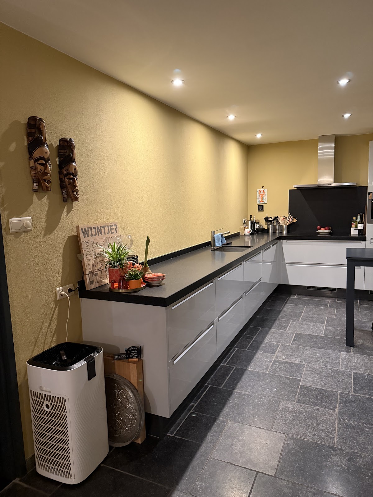 Mosterdgele accentwand in een moderne keuken na binnenschilderwerk.